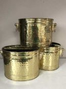 Three oval brass buckets