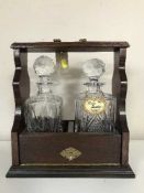A mahogany two decanter tantalus