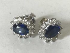 A pair of 18ct gold diamond and sapphire cluster earrings