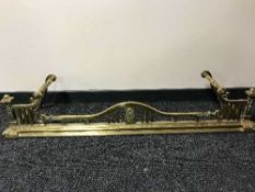 An early 20th century brass fire curb