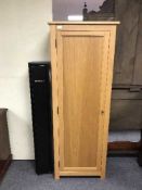 An oak cabinet containing a Fortify gun cabinet with keys