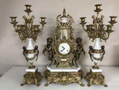 An ornate gilt three-piece clock garniture.