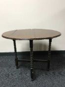 A folding oak table on bobbin legs