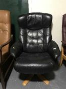 A black leather swivel armchair
