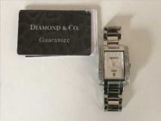 A Diamond and Co Gentleman's wrist watch, in original retail box,