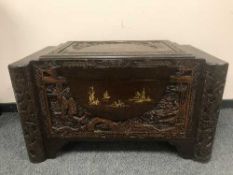 An Oriental carved camphor wood chest