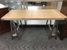 A reclaimed pine topped coffee table on metal supports