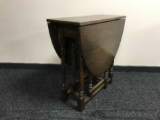 A narrow oak drop leaf table