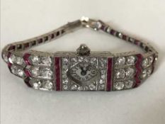 A superb quality ruby and diamond cocktail watch in platinum case, approximately 6cts of diamonds.