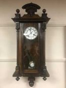 A mahogany wall clock with enamel dial