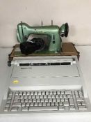 A cased Husquanvana sewing machine and a Silver Reed typewriter