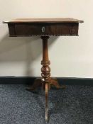 A mahogany pedestal sewing table