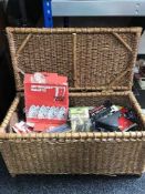 A wicker hamper of car and bike parts