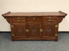 An Oriental low sideboard