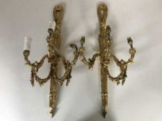 A pair of gilt metal three way wall sconces