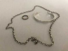 Four items of silver jewellery to include bangle, tie clip etc,