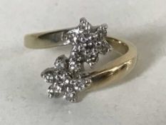 A 9ct gold diamond double cluster ring, approximately 0.5ct.