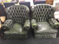 A pair of green buttoned Chesterfield armchairs