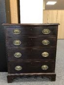 A Georgian style four drawer chest on bracket feet