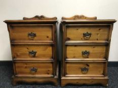 A pair of pine three drawer bedside chests