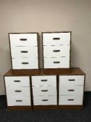 Five teak effect three drawer chests