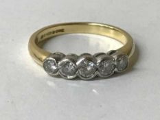 An 18ct gold five stone diamond ring