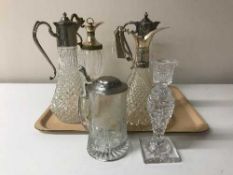 Four cut glass claret jugs with plated mounts,