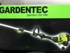 A boxed Garden Tech petrol grass trimmer