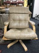 A leather adjustable swivel armchair