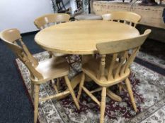 A circular beech kitchen table and four chairs