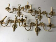 Four brass two-way wall lights