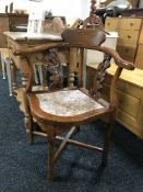 An oriental style corner armchair with rouge marble seat