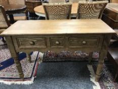 A reclaimed pine three drawer side table