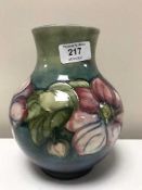 A Moorcroft Clematis vase with blue\green background, height 19cms.