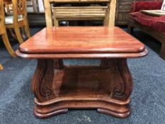A stained oak two tier coffee table
