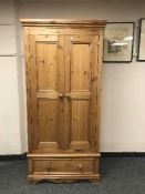 A pine double wardrobe fitted a drawer