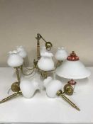 A brass five way chandelier with glass globes together with matching wall lights and a glass