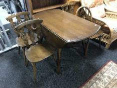 An Ercol drop leaf table and four chairs
