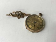 A 9ct gold lady's fob watch, together with a Victorian gold brooch,