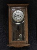An Edwardian oak wall clock