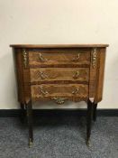 An inlaid walnut ormolu mounted three drawer chest
