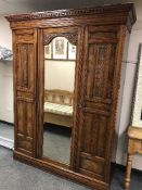 A late Victorian walnut mirror door wardrobe