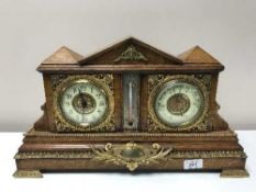 An antique oak bracket clock with gilt and enamelled dial, fitted with a barometer,