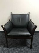 A late 20th century black leather framed armchair