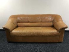 A brown leather three seater settee