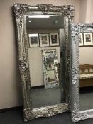 A large silvered ornate rectangular mirror,