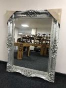 A very large silvered framed mirror