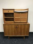 A teak double door cabinet and a teak telephone table