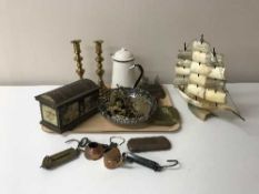 Two trays of brass and copper ware, antique domed topped tin, balance scales,