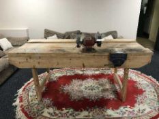 A large pine work table fitted vice and bench grinder